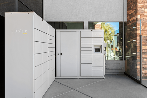 A white LUXER unit is installed outside a building.