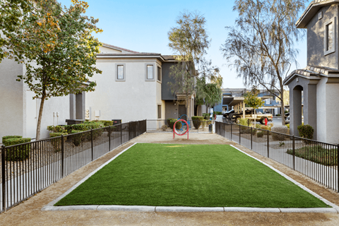 A small grassy area in front of a building.