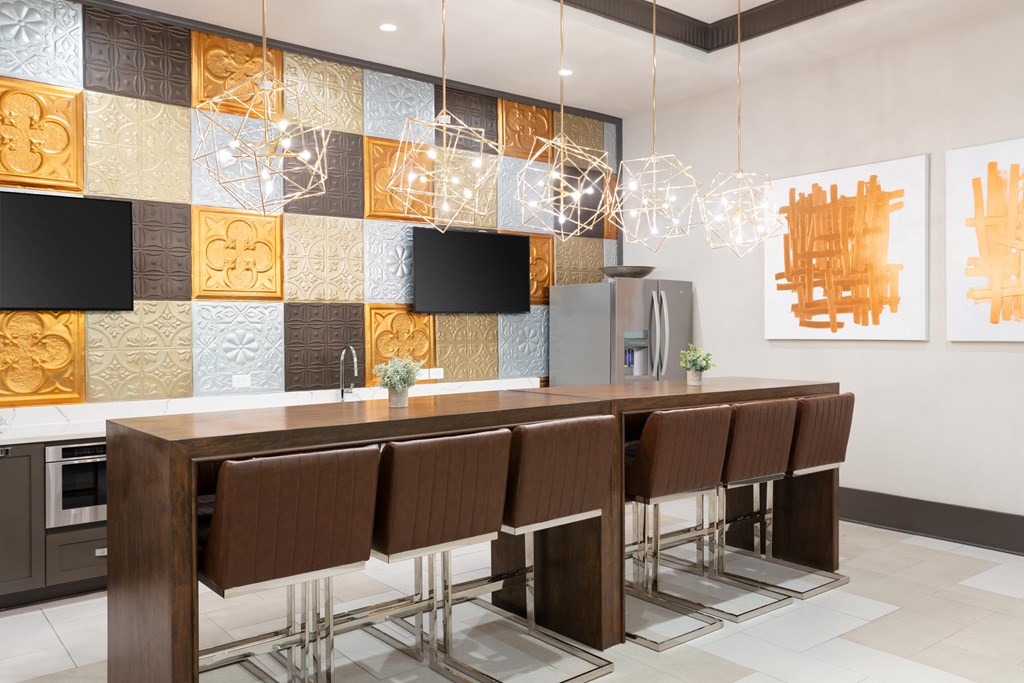A modern kitchen with brown chairs and a wooden table.