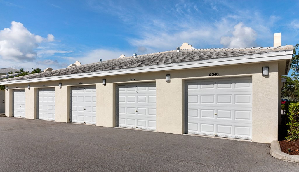 A row of white garage doors are closed.
