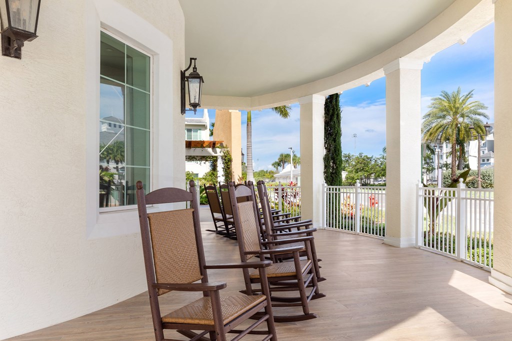 A row of chairs are on a patio.