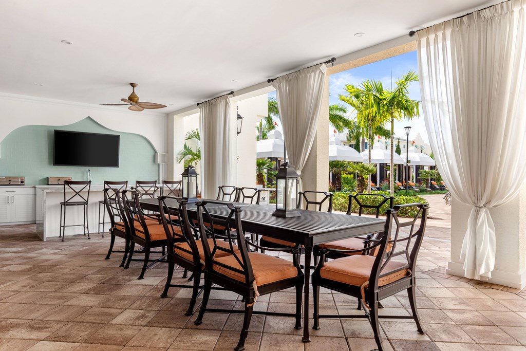A dining room with a long table and chairs.