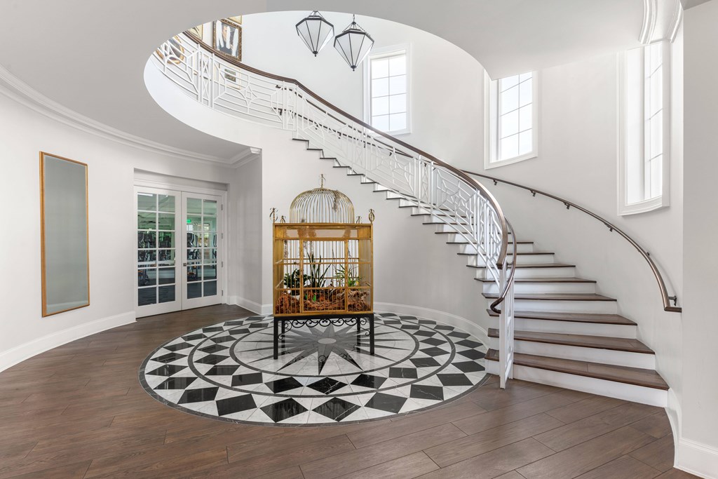 A spiral staircase in a home with a black and white floor.