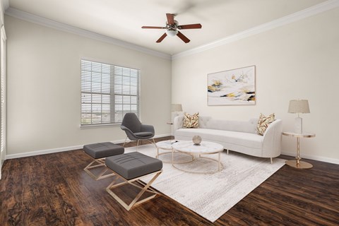 A living room with a white couch, a chair, a coffee table, and a painting on the wall.