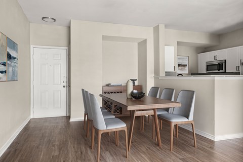 A dining room with a table and chairs.