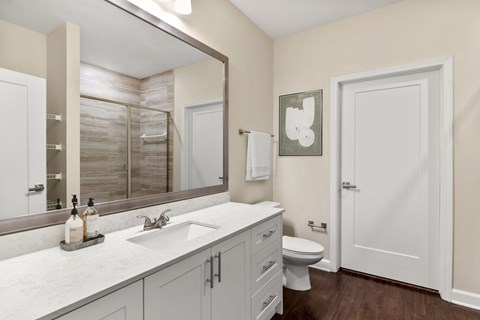 A bathroom with a white toilet and a white sink.