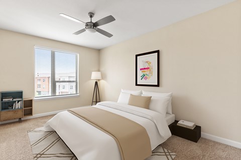 A bedroom with a large bed and a ceiling fan.