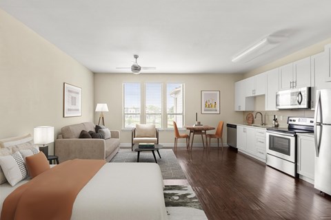 A well-lit, modern kitchen and living room with a large bed in the foreground.