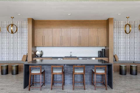 A modern kitchen with wooden cabinets and a dark countertop.