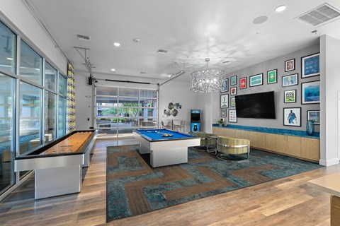 A room with a pool table and a bar.