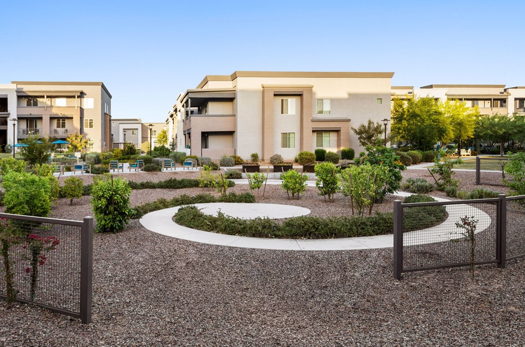 A modern building with a circular garden in front.