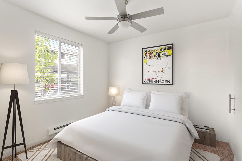 A bedroom with a large bed and a picture of Copenhagen on the wall.