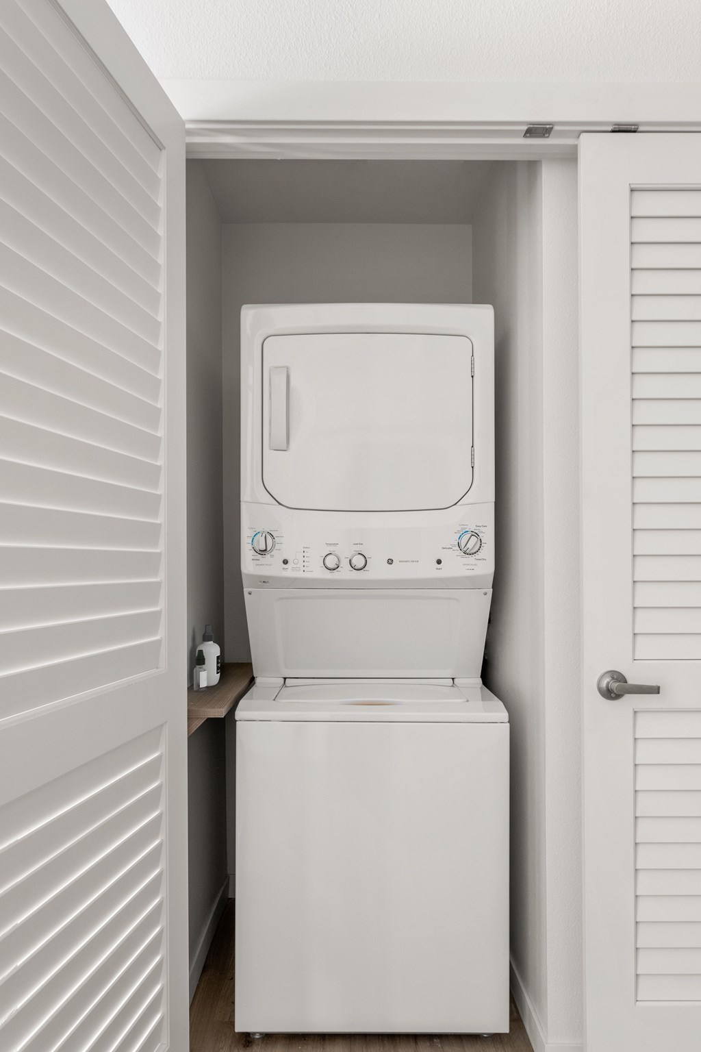 A white toilet is installed in a small white room.