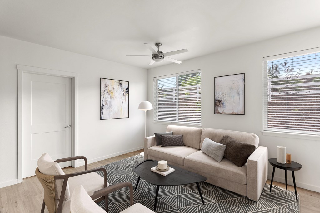 A living room with a couch, chair, and table.