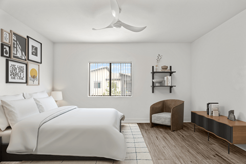 A bedroom with a large bed and a chair.