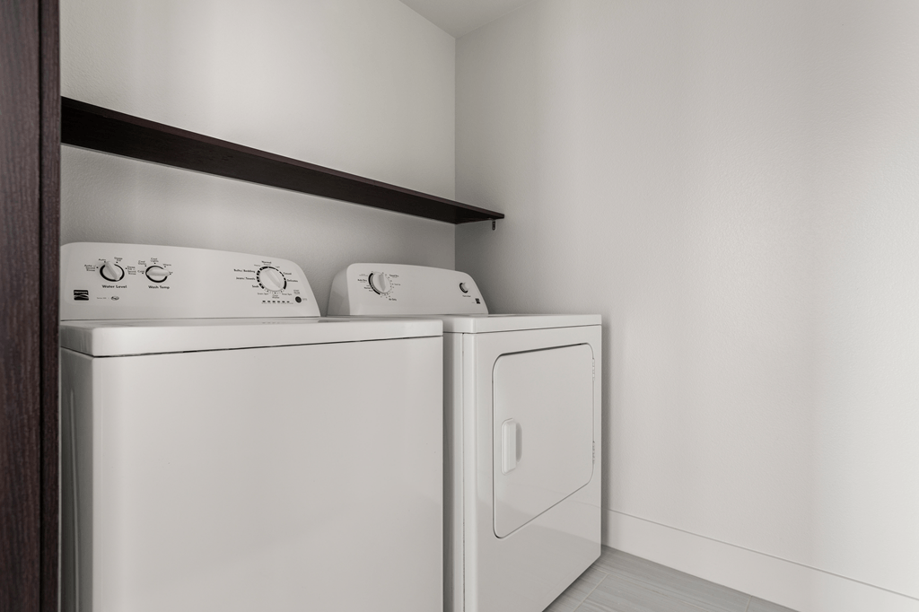 Two washing machines in a laundry room.