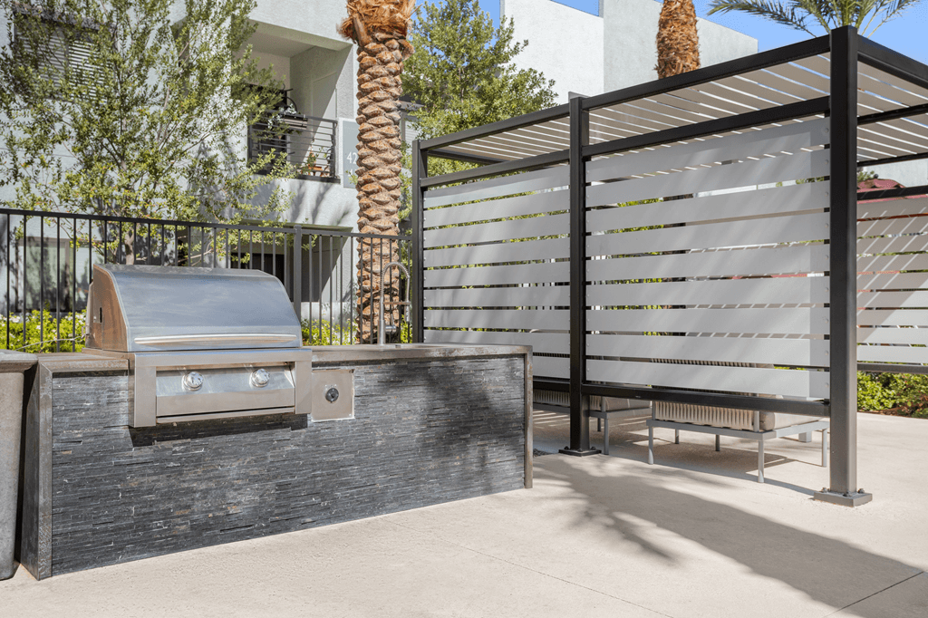 A black gate with a white sign on it.