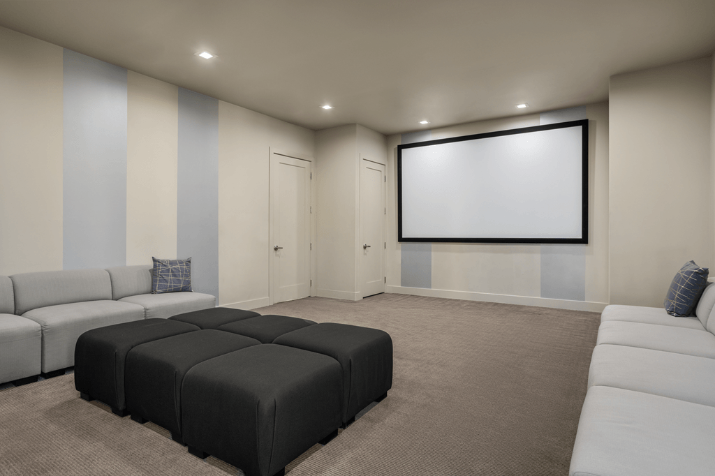 A modern living room with a large couch and a flat screen TV.