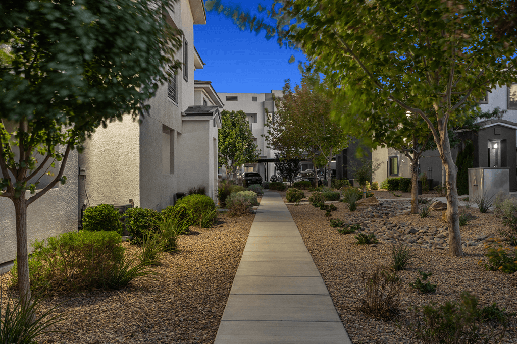 A pathway in a garden with a gravel bed on either side.