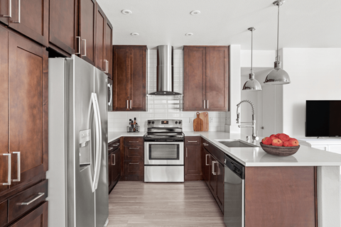 A modern kitchen with wooden cabinets and stainless steel appliances.