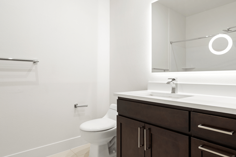 A white toilet sits next to a sink in a bathroom.