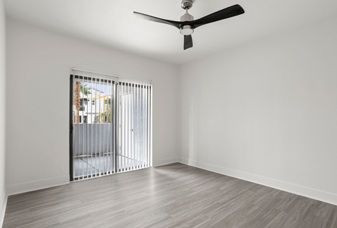 A room with a sliding door and a ceiling fan.