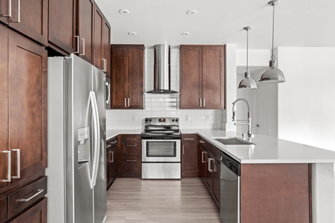 A modern kitchen with wooden cabinets and stainless steel appliances.