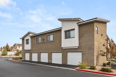 A modern house with a brown and beige exterior and a white garage door.