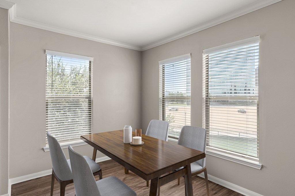 A dining room with a wooden table and chairs.