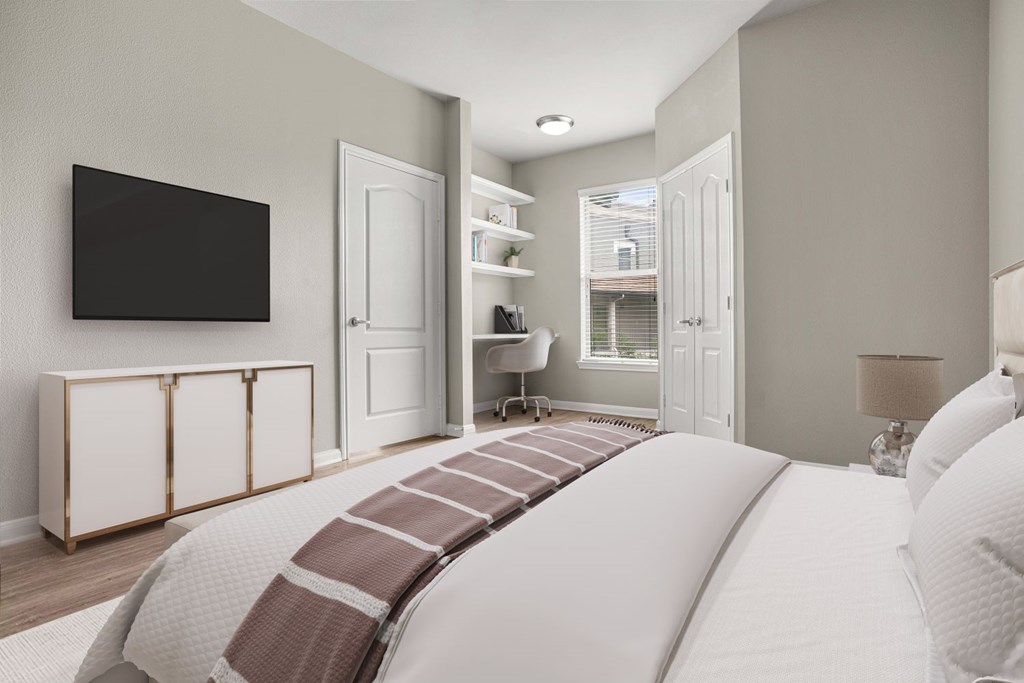 A bedroom with a large bed and a television on a cabinet.