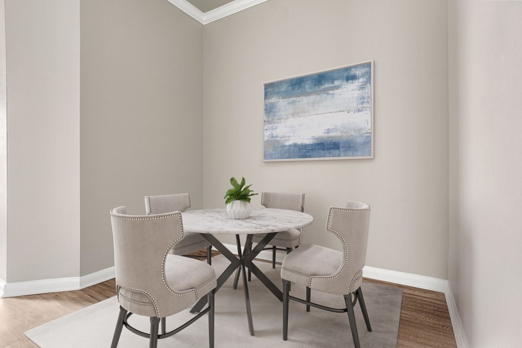 A dining room with a white table and chairs.