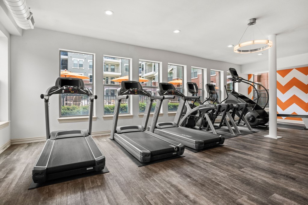 A gym with treadmills and elliptical machines.