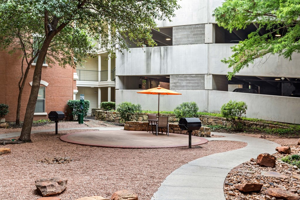 A courtyard with a table and chairs and a mailbox.