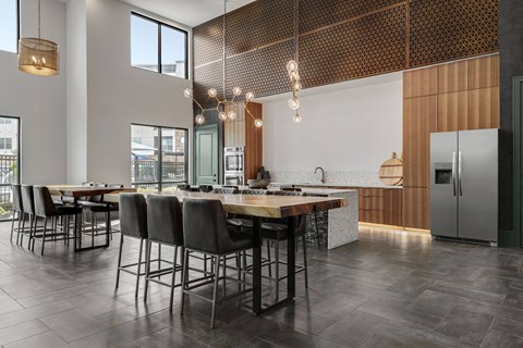 A modern kitchen with a dining table and chairs.