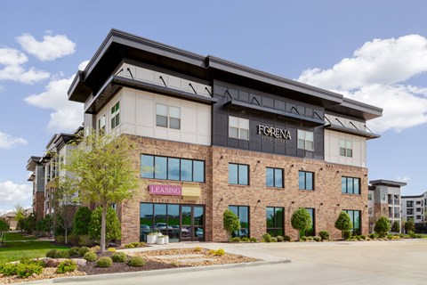 A Forenna leasing building with a parking lot in front.