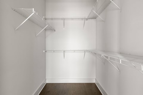 Empty room with white walls and wooden floor.