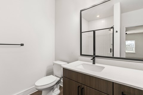 A white toilet sits next to a sink in a bathroom.
