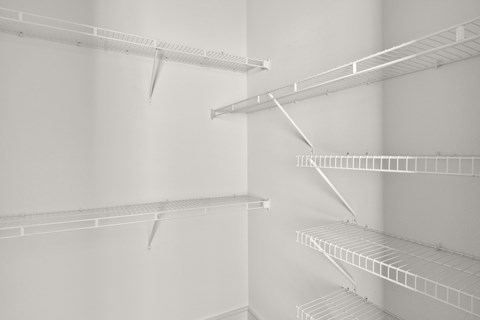 Empty white shelves in a room.