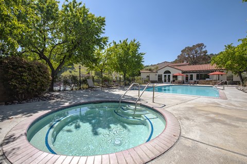 A round pool with a hot tub in the middle.