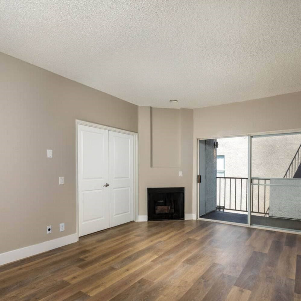 A room with a fireplace and a balcony.