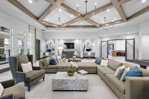 A spacious living room with a variety of seating options and a coffee table in the center.