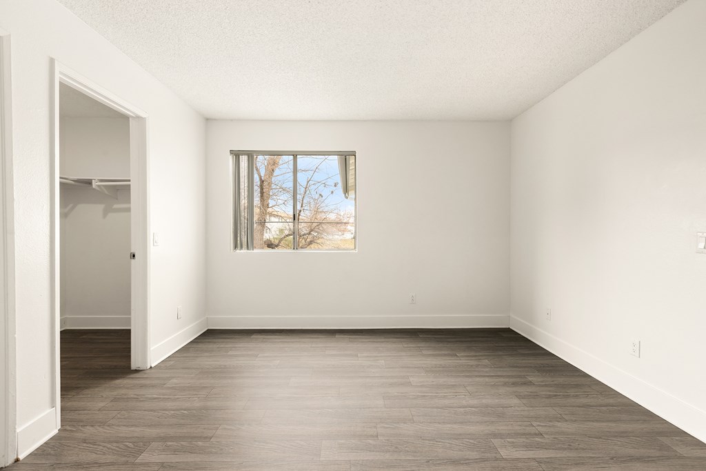 Empty room with a window and a door.