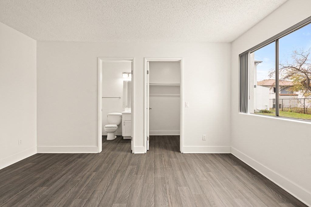 A room with a toilet and a bed in it.