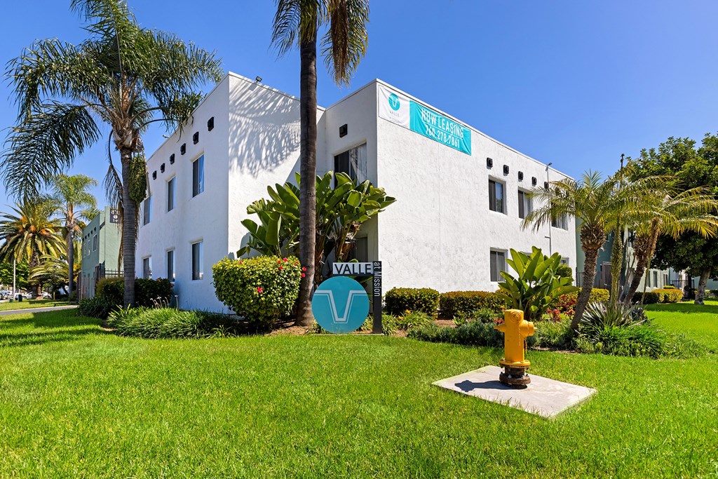 A white building with a blue sign that says "Not So Fast" on it.