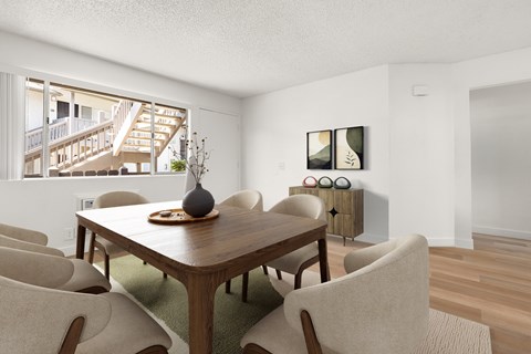 A dining room with a wooden table and chairs.
