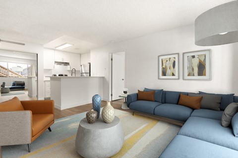 A living room with a grey couch and a grey coffee table with a blue couch and orange pillows.