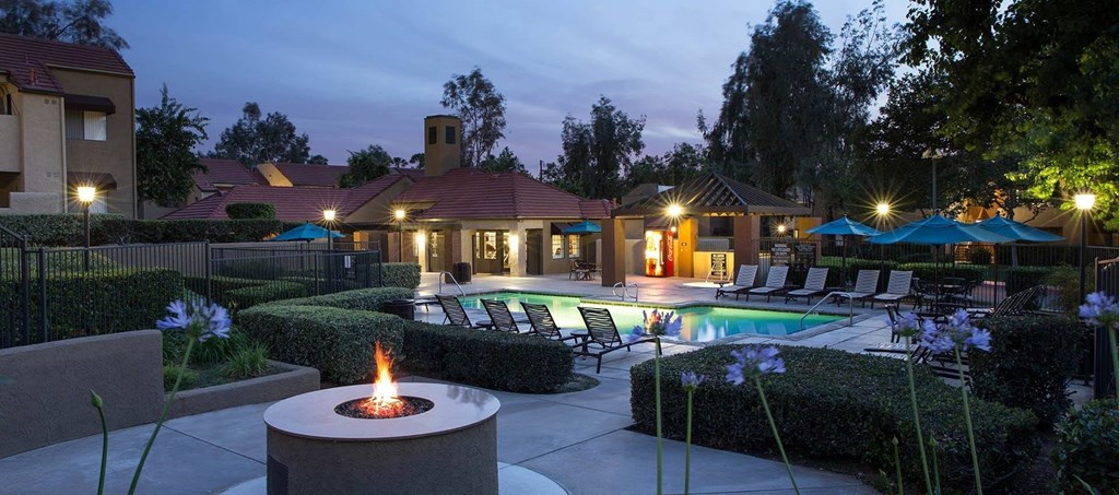 A backyard with a fire pit and a pool.