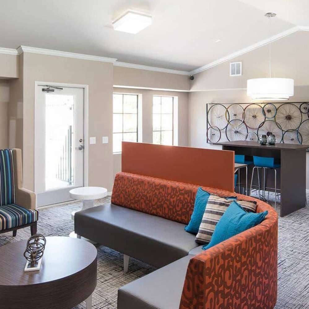 A living room with a sofa, armchair, and coffee table.