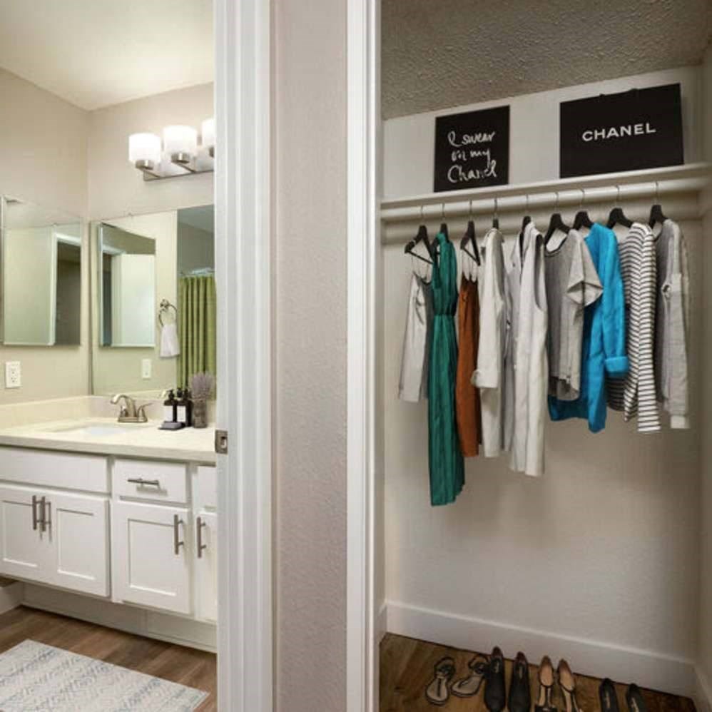 Clothes hanging on a rack in a room.