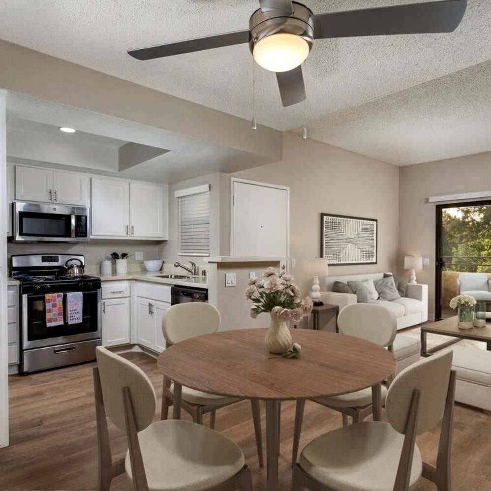 A modern kitchen with a dining table set for four.